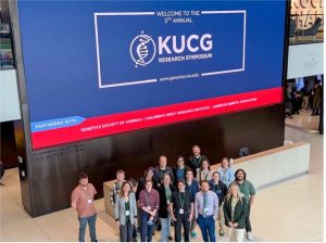 A photo of a group of attendees in the entrance way of the Jayhawk Welcome Center with the organizing committee